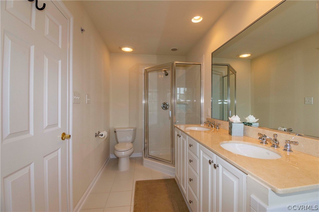 1122 Hyde Lane Henrico, VA 23229 - Photo 25 of 50 a bathroom with a granite countertop sink a toilet a shower and a mirror