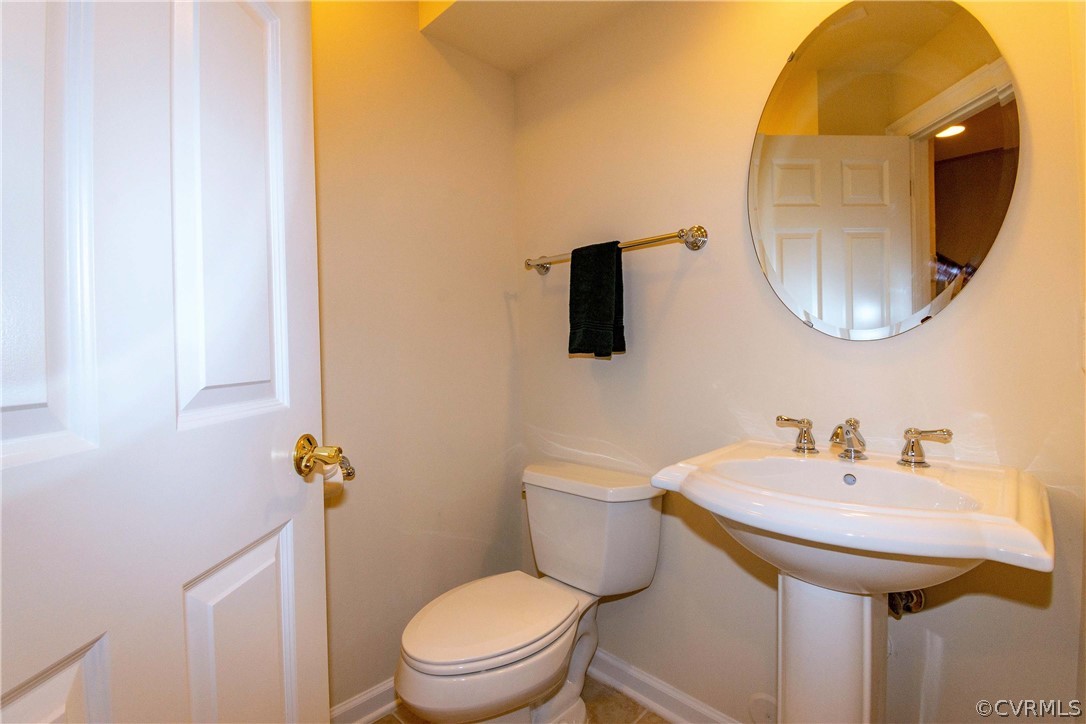 1122 Hyde Lane Henrico, VA 23229 - Photo 35 of 50 a bathroom with a toilet a sink and mirror