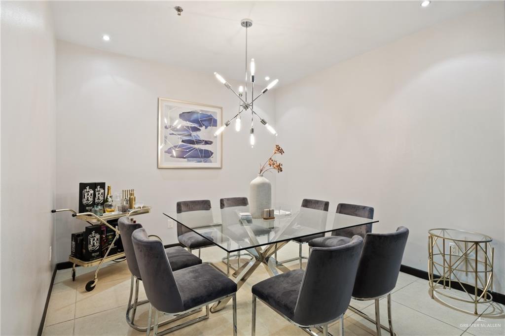 813 Travis Street, Unit 203 Mission, TX 78572 - Photo 8 of 30 a view of a dining room with furniture and a chandelier