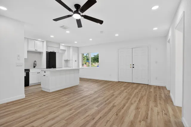 a view of an empty room with wooden floor