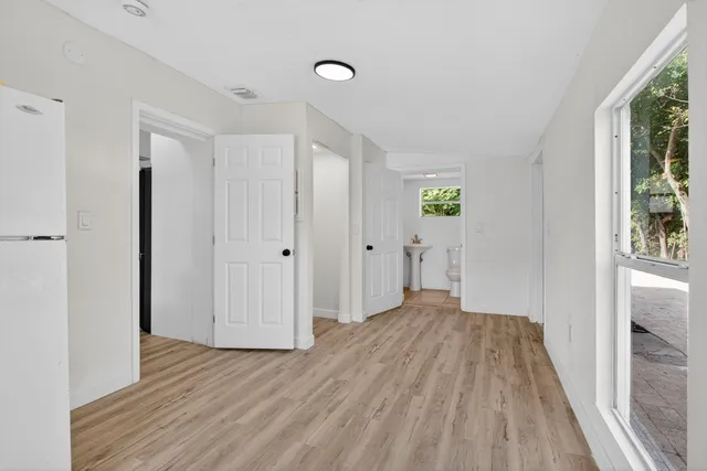 a view of a room with wooden floor and window