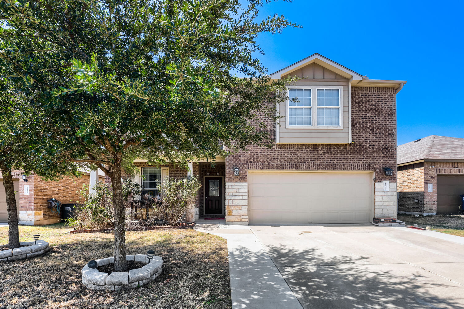153 Marcheeta Way Leander, TX 78641 - Photo 1 of 17 A classic brick exterior and concrete driveway frame this two-story residential home.