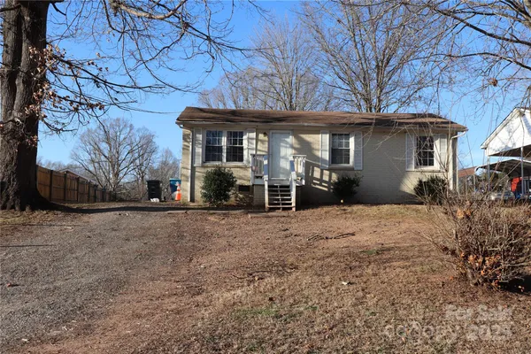 a view of a house with a yard and garage