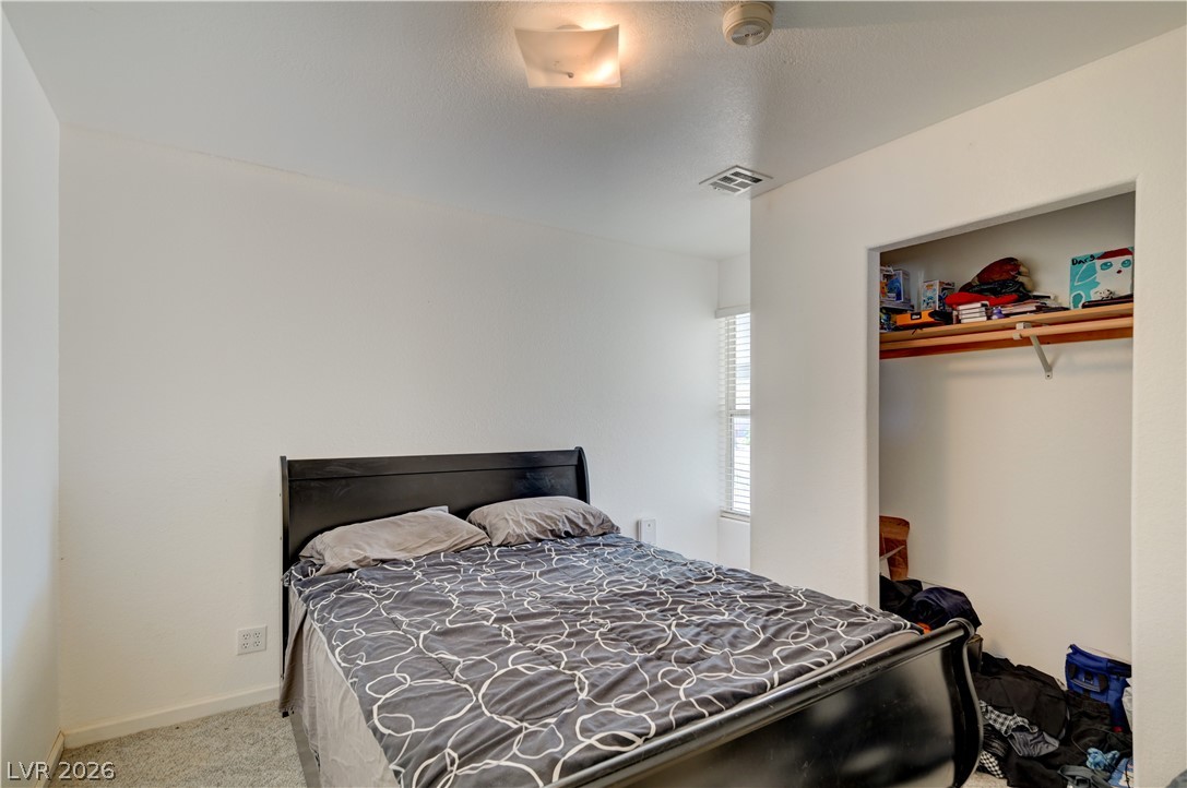590 East Encinitas Street Searchlight, NV 89046 - Photo 37 of 39 Bright and airy bedroom features soft carpeting and a convenient closet space.