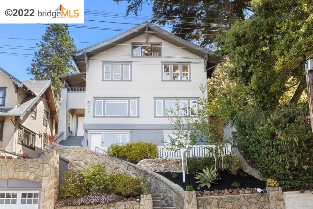 879 Regal Road Berkeley, CA 94708 - Photo 1 of 1 a view of a white house next to a yard with plants and trees