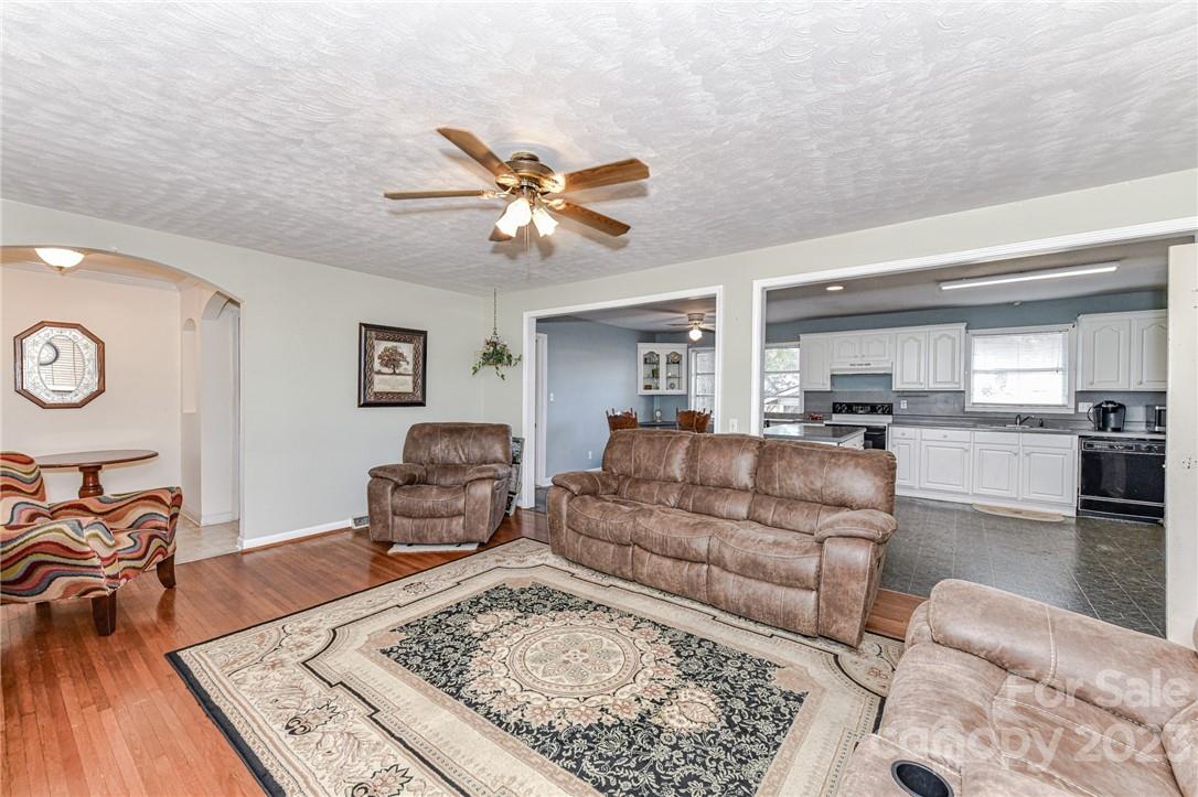 6308 Indian Trail Fairview Road Hemby Bridge, NC 28079 - Photo 11 of 36 a living room with furniture and a wooden floor