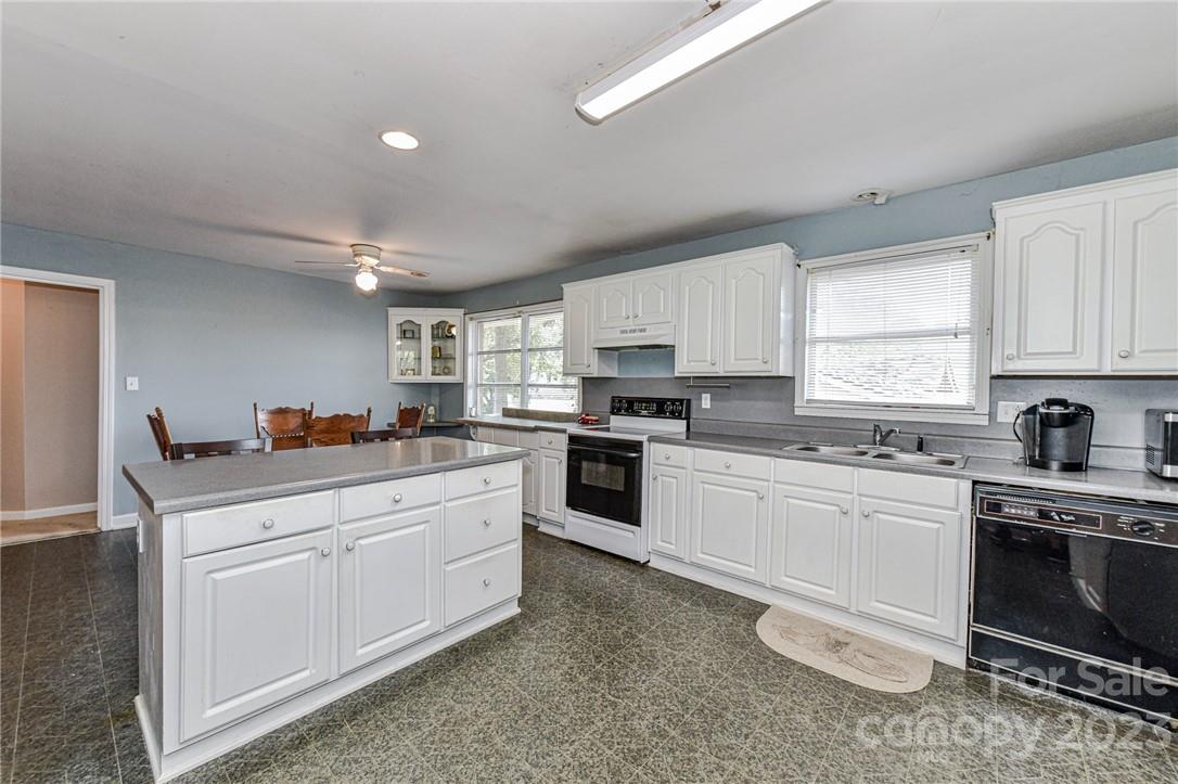 6308 Indian Trail Fairview Road Hemby Bridge, NC 28079 - Photo 13 of 36 a kitchen with a white cabinets and white appliances