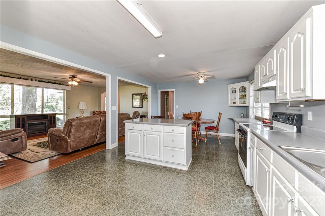 6308 Indian Trail Fairview Road Hemby Bridge, NC 28079 - Photo 14 of 36 a large white kitchen with a large window