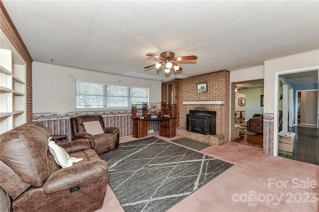 6308 Indian Trail Fairview Road Hemby Bridge, NC 28079 - Photo 20 of 36 a living room with furniture a fireplace and a large window