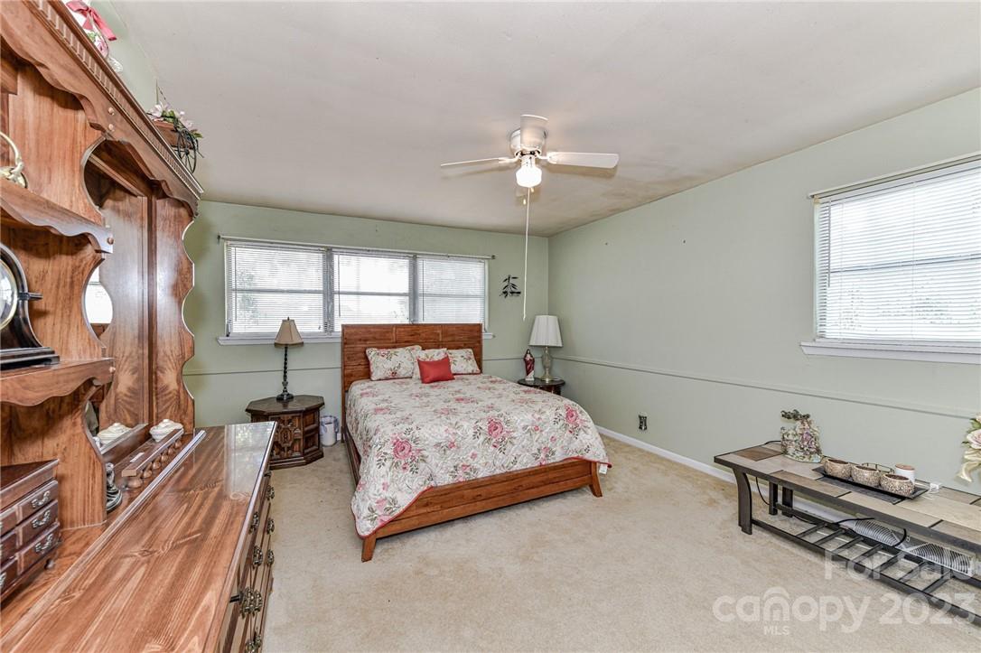 6308 Indian Trail Fairview Road Hemby Bridge, NC 28079 - Photo 24 of 36 a bedroom with a bed and a chandelier