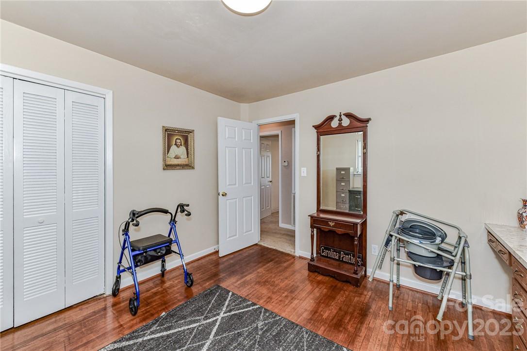6308 Indian Trail Fairview Road Hemby Bridge, NC 28079 - Photo 30 of 36 a living room with furniture a dining table and wooden floor