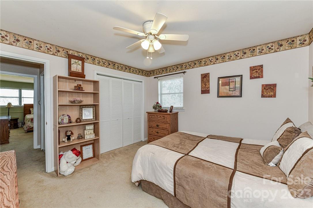 6308 Indian Trail Fairview Road Hemby Bridge, NC 28079 - Photo 33 of 36 a bedroom with a bed and a chandelier