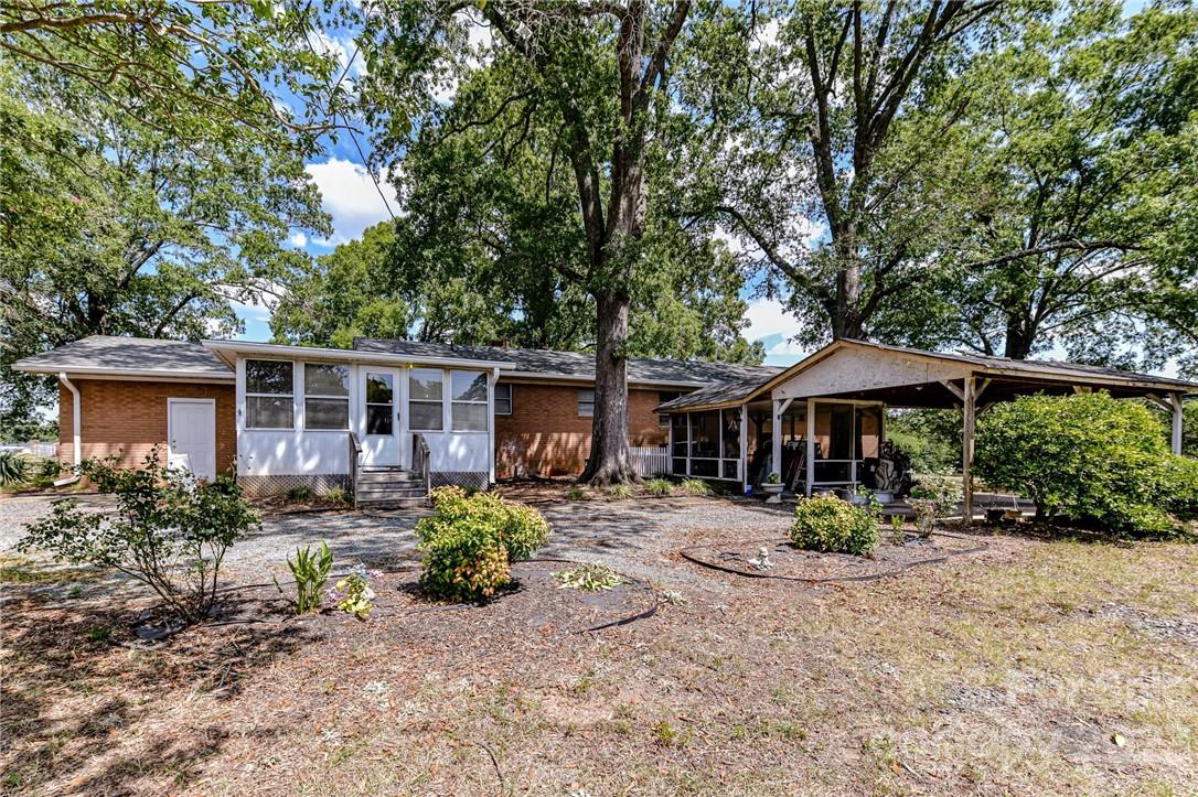6308 Indian Trail Fairview Road Hemby Bridge, NC 28079 - Photo 4 of 36 a backyard of a house with garden barbeque oven and outdoor seating