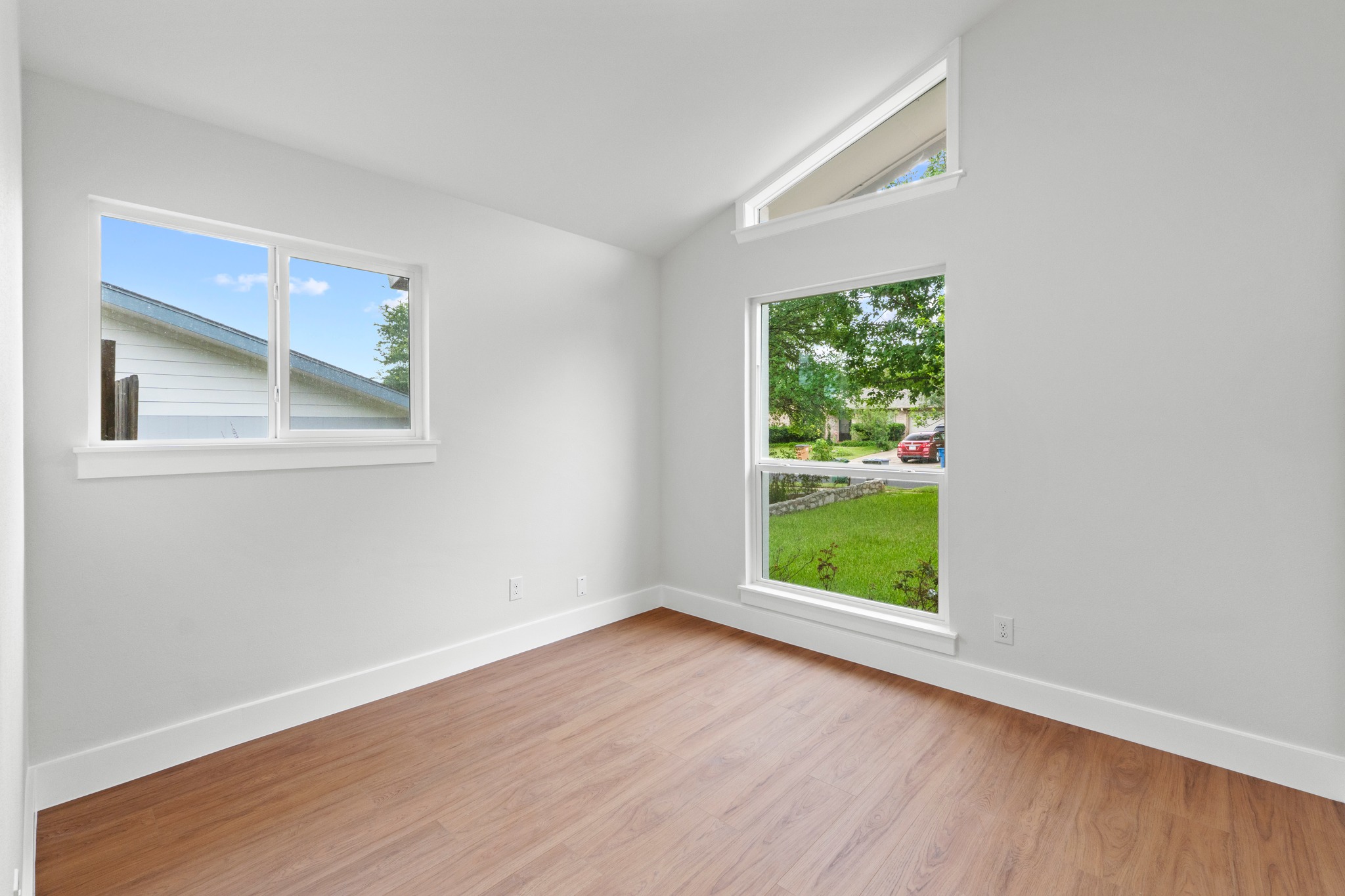 1608 Springer Lane Austin, TX 78758 - Photo 21 of 35 Bright interior space featuring wood-finish flooring, white baseboards, and white walls