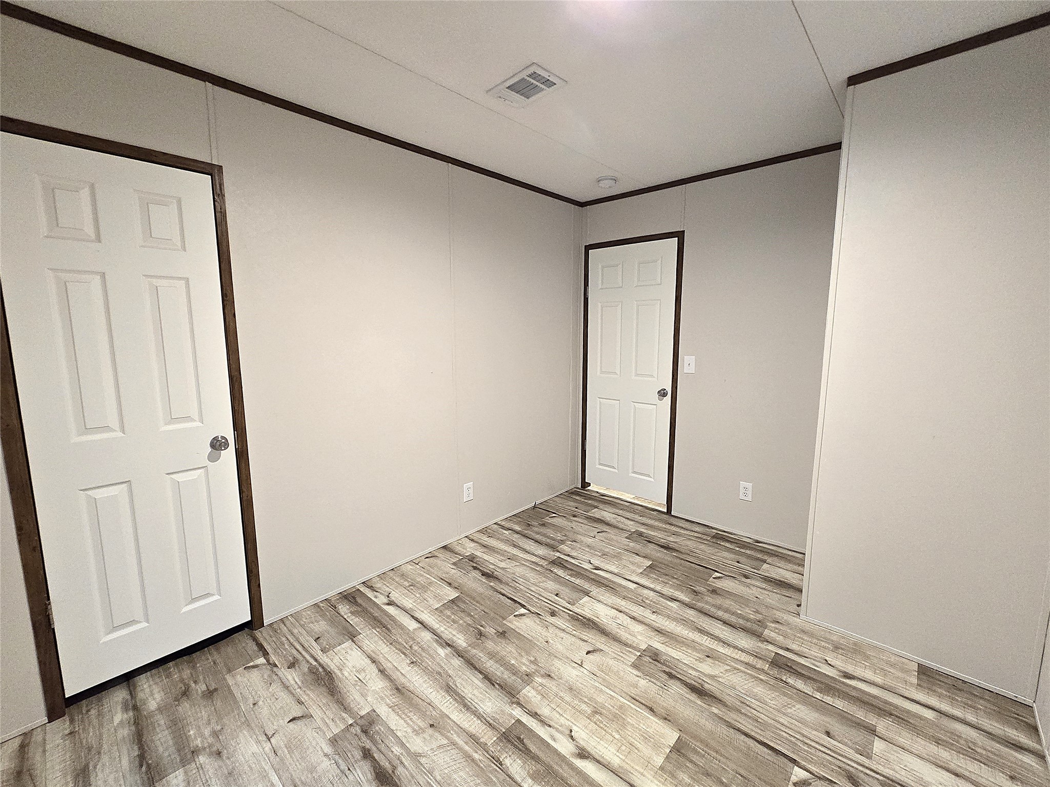 20 Morris Creek Road Coldspring, TX 77331 - Photo 14 of 29 This photo shows a bright room. It features a single window with blinds and a ceiling light, creating a clean and modern space suitable for a bedroom or office.