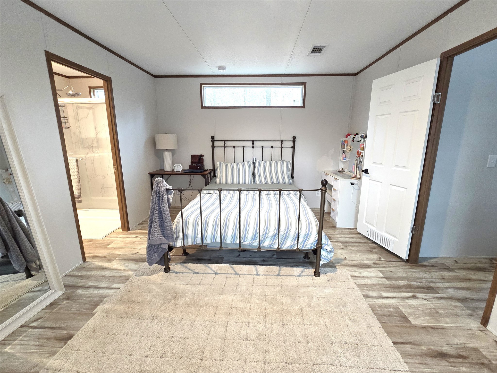 20 Morris Creek Road Coldspring, TX 77331 - Photo 16 of 29 This bright bedroom features an attached bathroom for convenience.