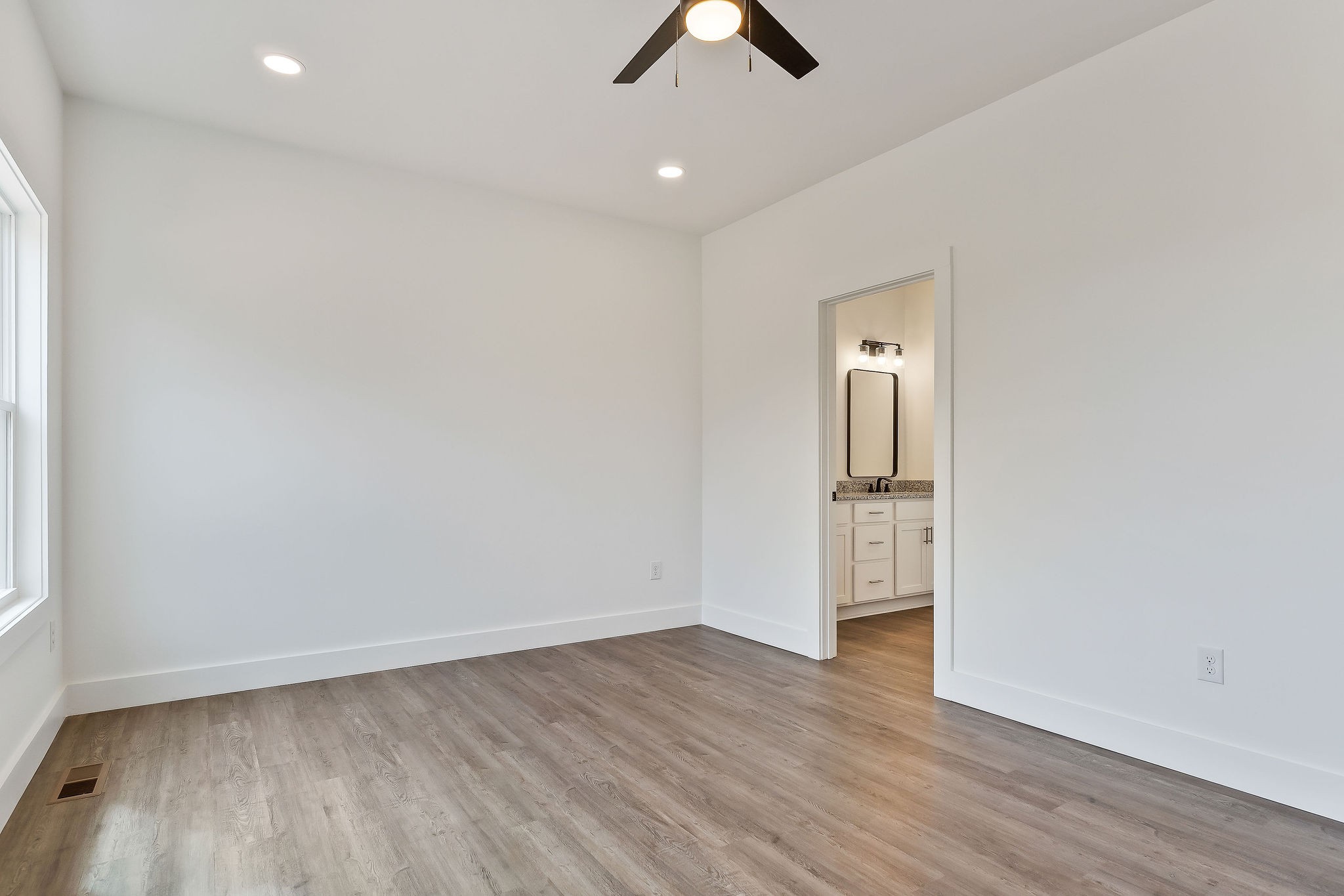 320 Johnson Chapel Road Sparta, TN 38583 - Photo 26 of 35 an empty room with wooden floor ceiling fan and window