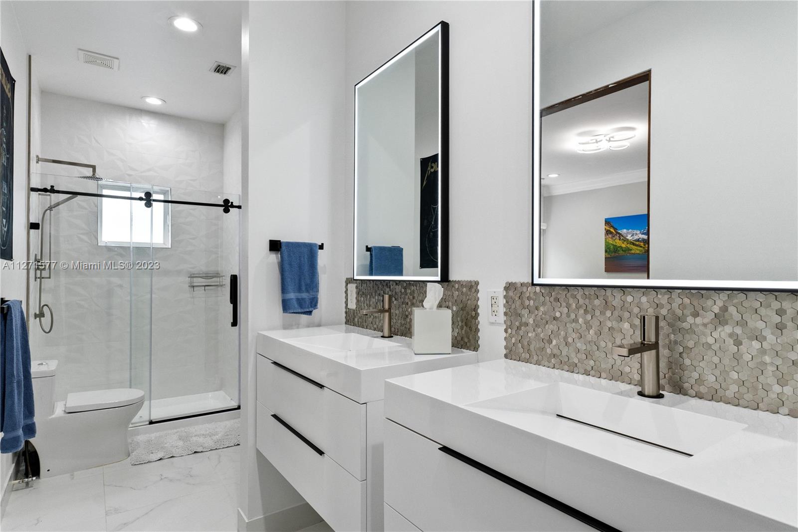 7740 Southwest 128th Street Pinecrest, FL 33156 - Photo 21 of 56 a bathroom with a double vanity sink mirror double and shower