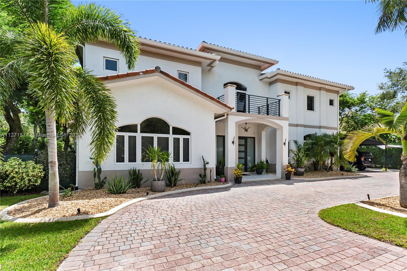 7740 Southwest 128th Street Pinecrest, FL 33156 - Photo 3 of 56 a front view of a house with a yard