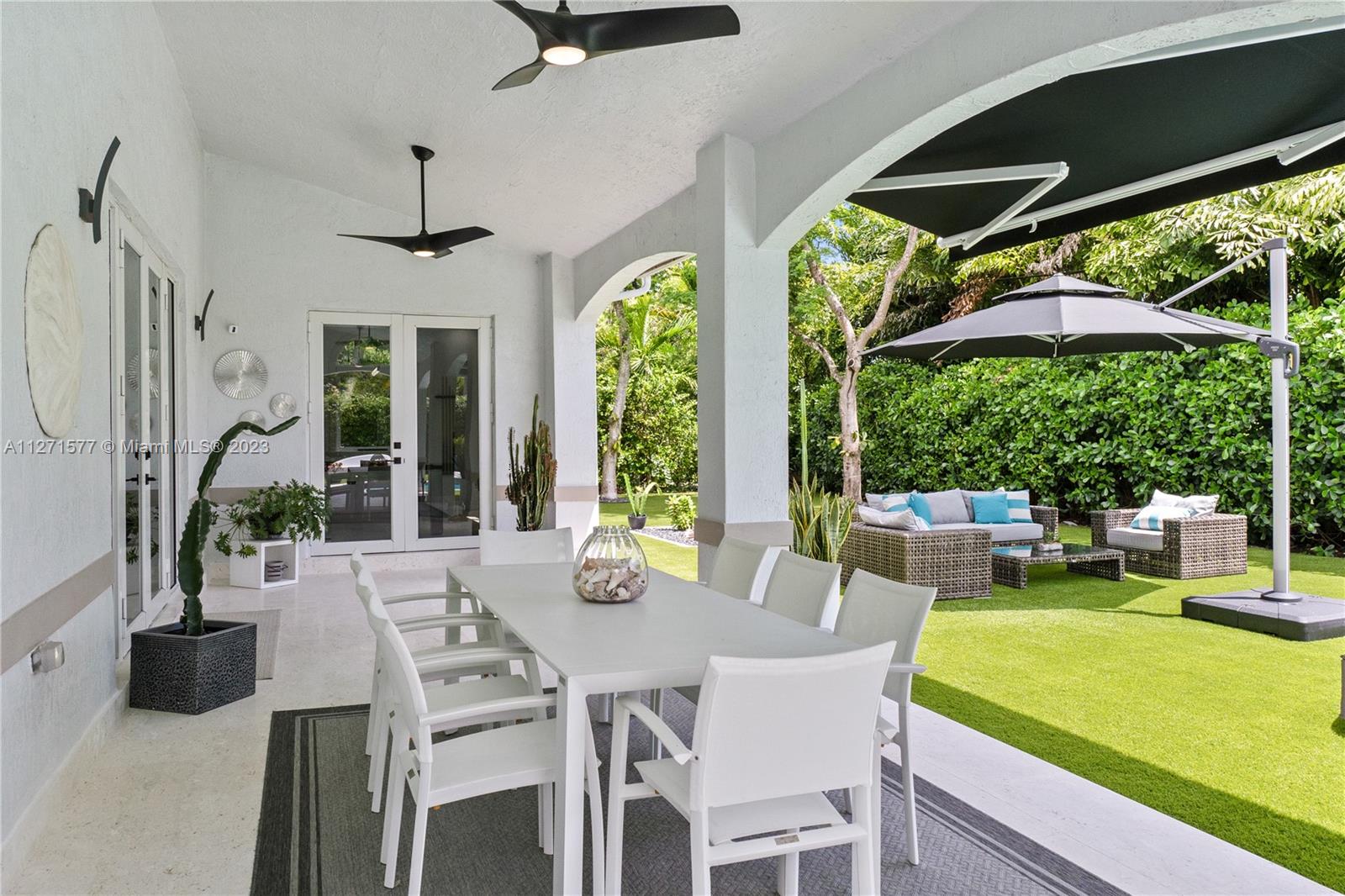7740 Southwest 128th Street Pinecrest, FL 33156 - Photo 35 of 56 a view of an outside dining space with furniture window and garden view