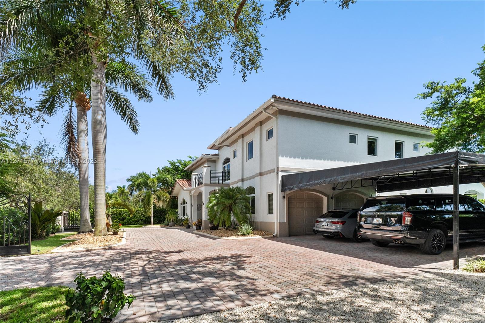 7740 Southwest 128th Street Pinecrest, FL 33156 - Photo 42 of 56 a car parked in front of a house