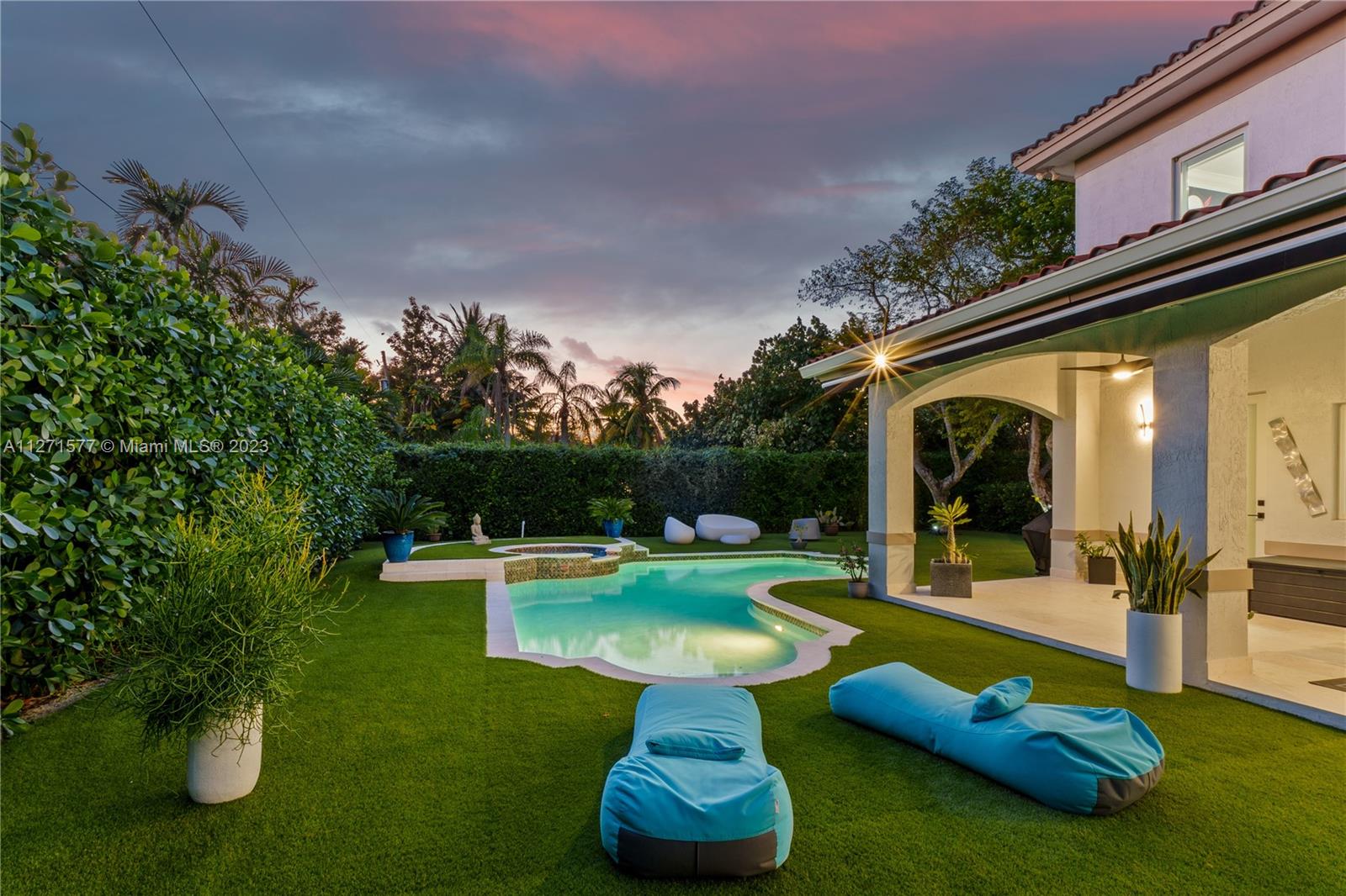 7740 Southwest 128th Street Pinecrest, FL 33156 - Photo 48 of 56 a view of a swimming pool with a bench in patio
