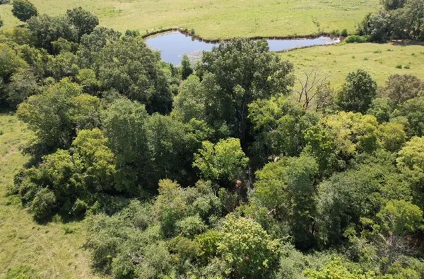 an aerial view of a houses with a lake view