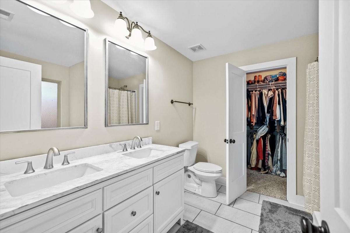 1048 Hurricane Creek Road Chattanooga, TN 37421 - Photo 17 of 31 a bathroom with a toilet a sink and a mirror