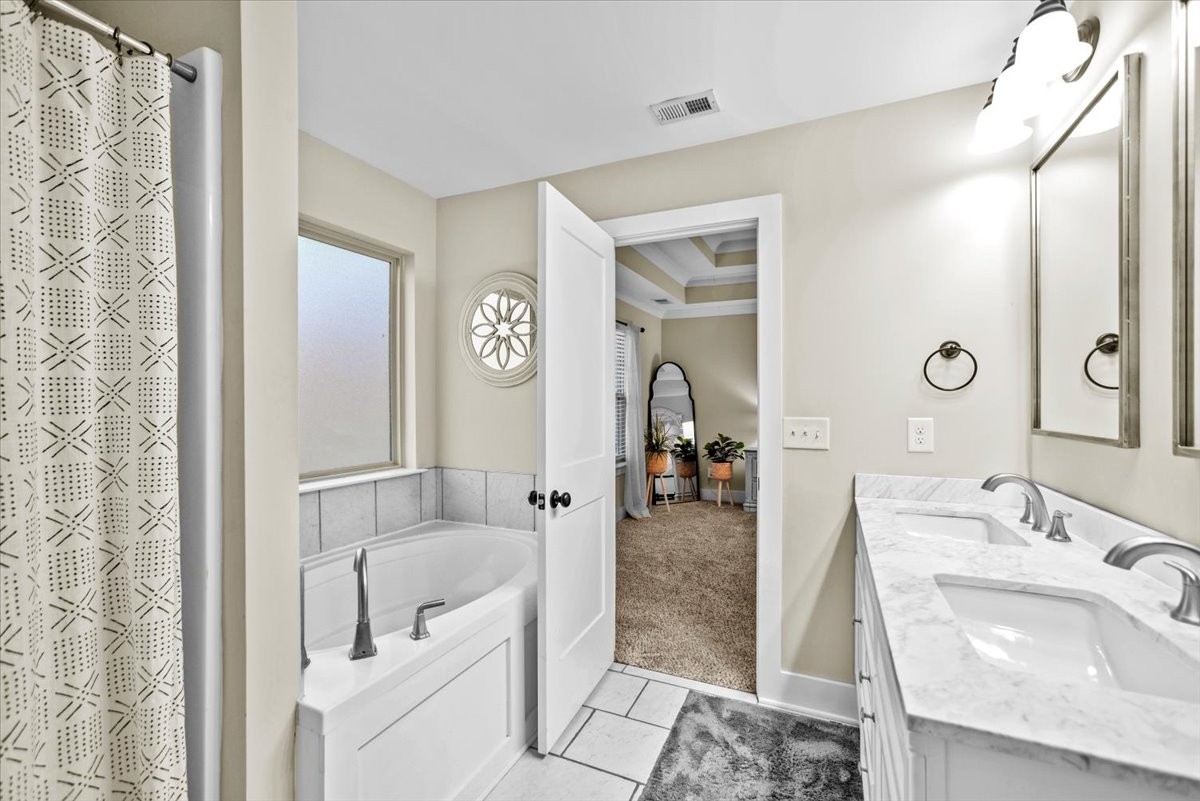 1048 Hurricane Creek Road Chattanooga, TN 37421 - Photo 18 of 31 a bathroom with a tub sink and mirror