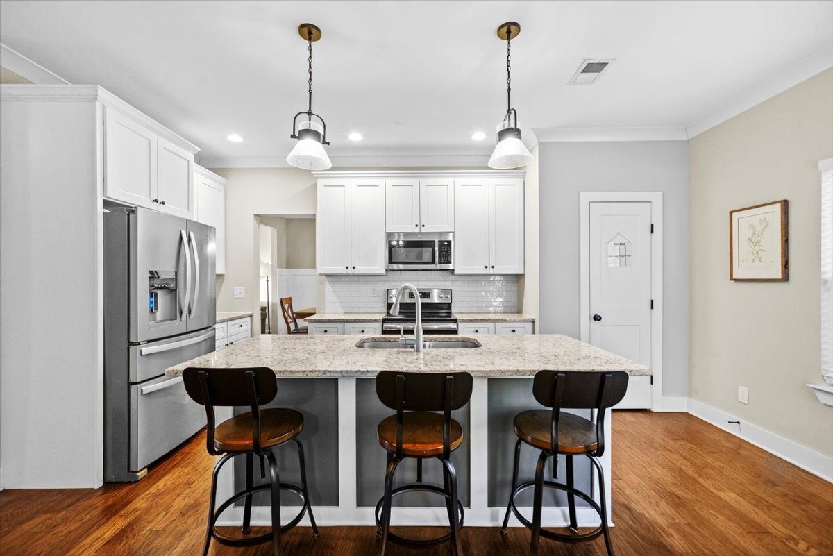 1048 Hurricane Creek Road Chattanooga, TN 37421 - Photo 6 of 31 a kitchen with stainless steel appliances granite countertop a dining table chairs refrigerator and cabinets