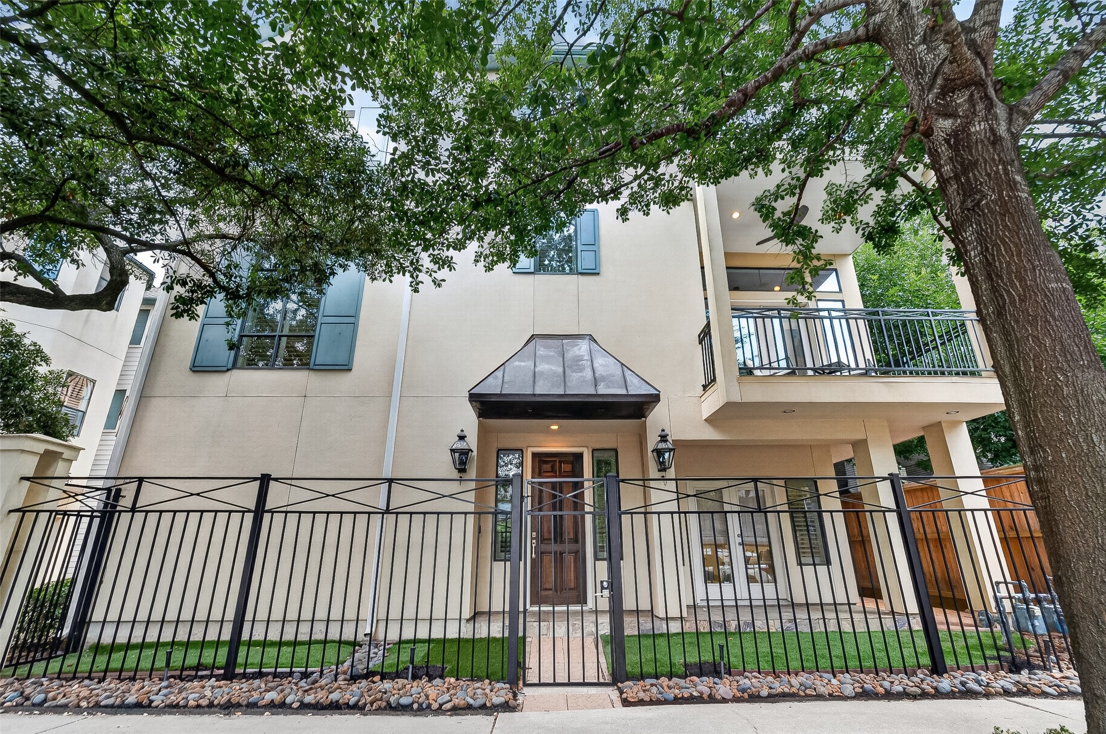 2034 Colquitt Street, Unit A Houston, TX 77098 - Photo 5 of 41 This classic 3-story home features a sleek exterior with large windows and a gated front entrance. It includes 3 balconies, well-maintained landscaping, and is shaded by mature trees, offering a blend of privacy and urban living.
