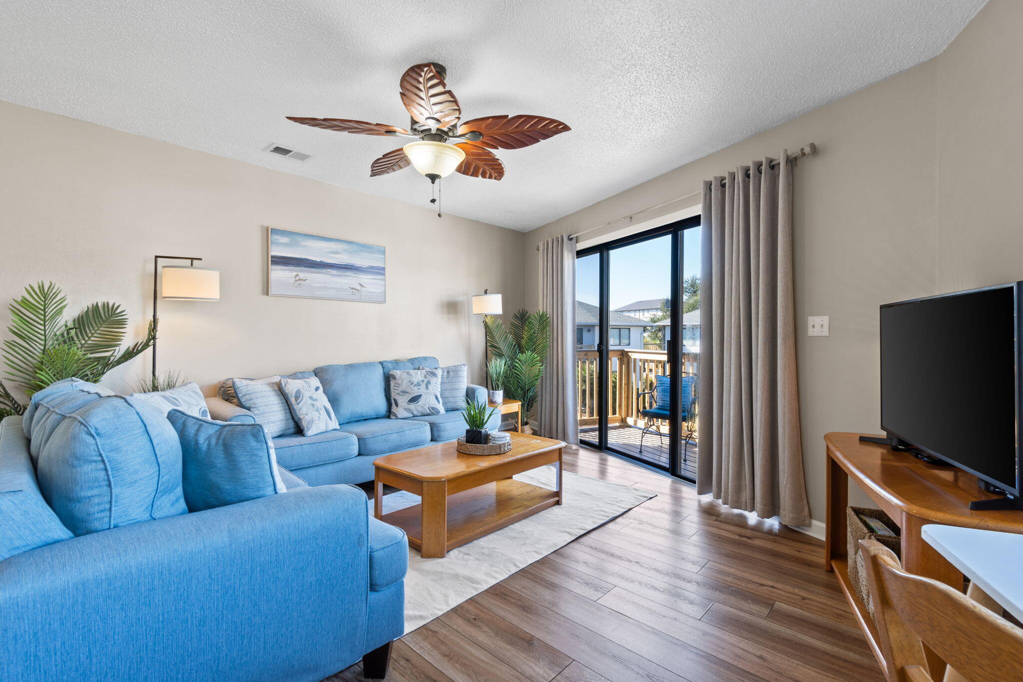 285 Payne Street, Unit 23B Miramar Beach, FL 32550 - Photo 12 of 41 a living room with furniture a flat screen tv and wooden floor
