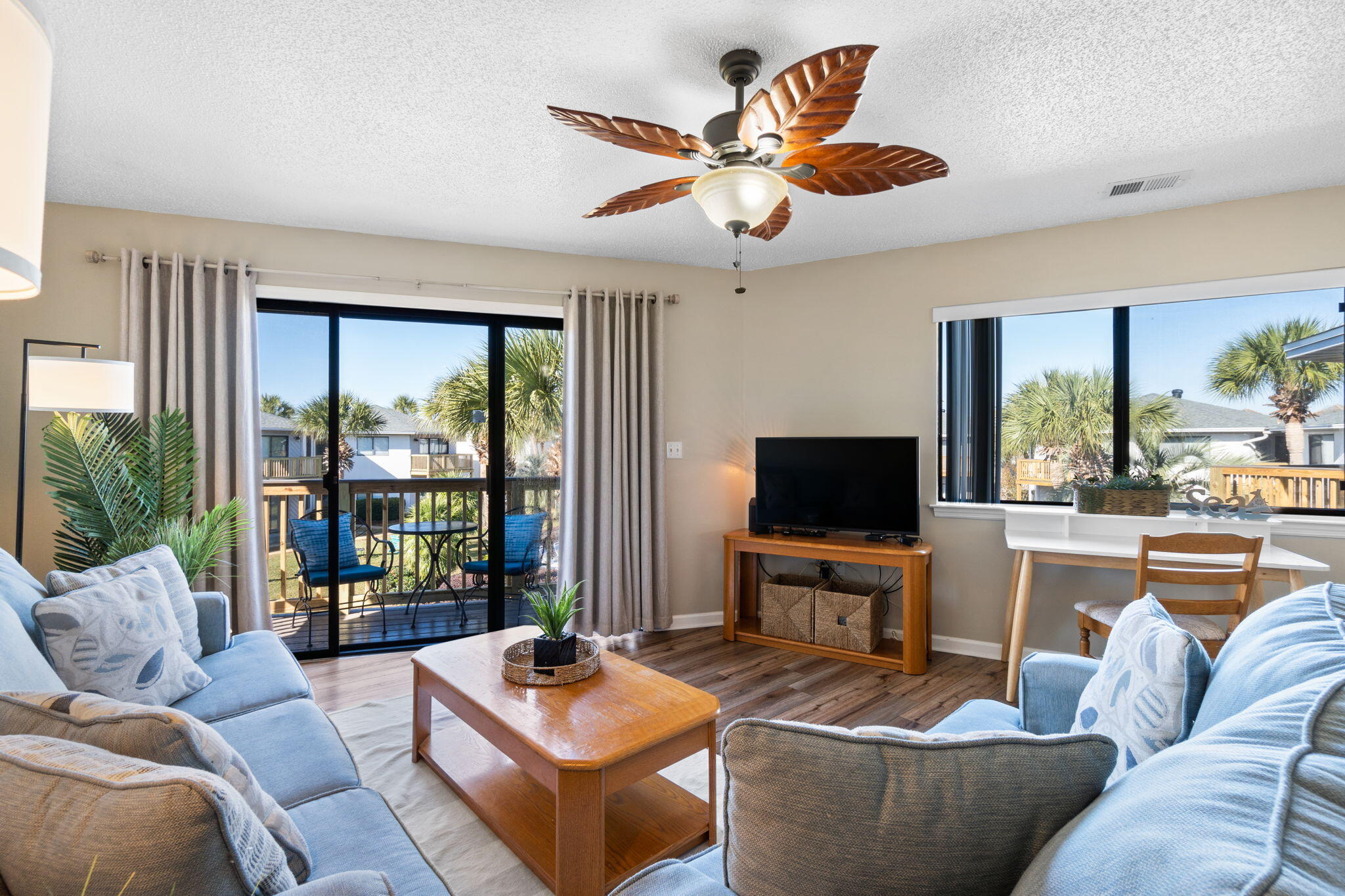 285 Payne Street, Unit 23B Miramar Beach, FL 32550 - Photo 14 of 41 a living room with furniture a flat screen tv and a large window