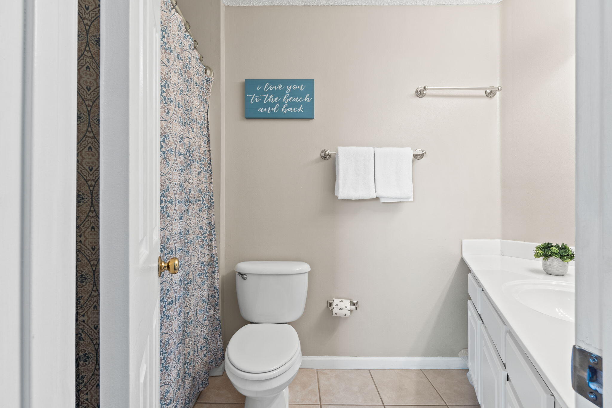 285 Payne Street, Unit 23B Miramar Beach, FL 32550 - Photo 20 of 41 a white toilet sitting next to a white sink and vanity