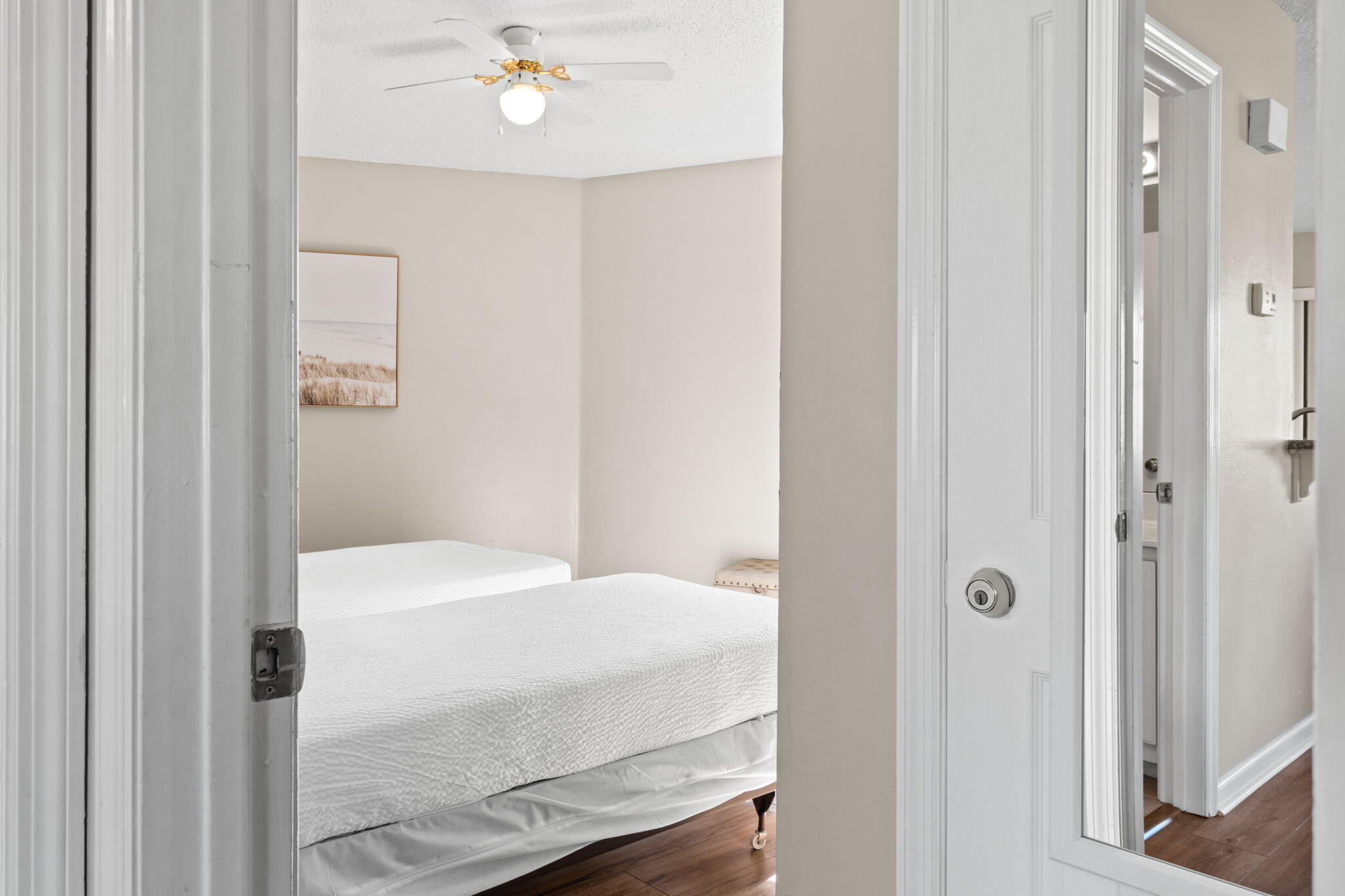 285 Payne Street, Unit 23B Miramar Beach, FL 32550 - Photo 22 of 41 a bedroom with a bed and a chandelier