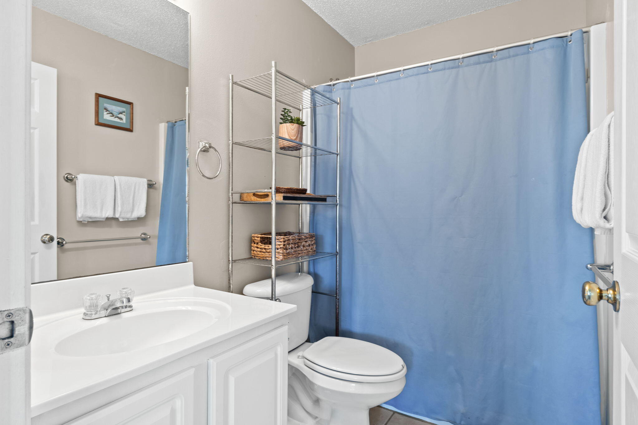 285 Payne Street, Unit 23B Miramar Beach, FL 32550 - Photo 25 of 41 a bathroom with a sink a toilet and shower curtain