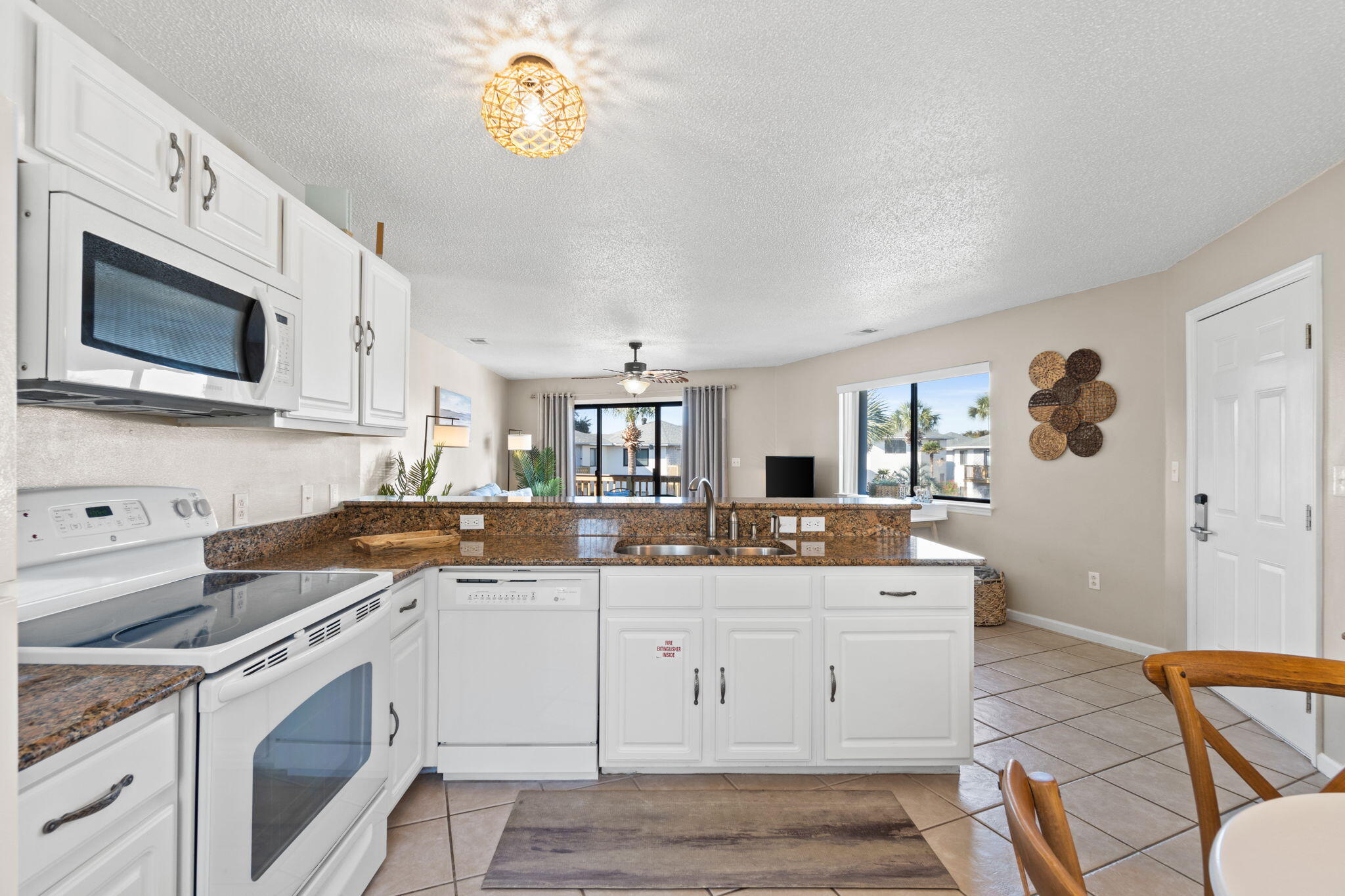 285 Payne Street, Unit 23B Miramar Beach, FL 32550 - Photo 7 of 41 a kitchen with a sink stove and cabinets