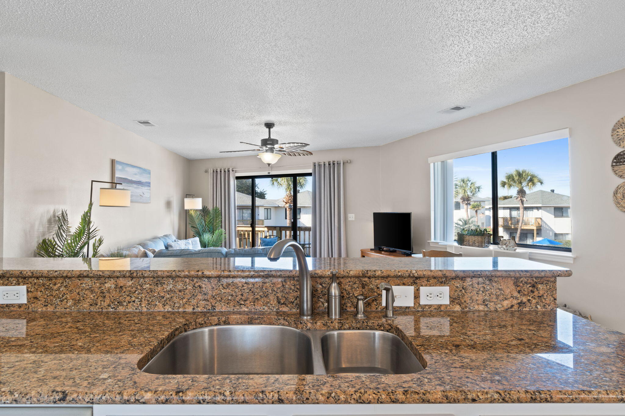 285 Payne Street, Unit 23B Miramar Beach, FL 32550 - Photo 8 of 41 a kitchen with stainless steel appliances granite countertop a sink a microwave cabinets and a dining table