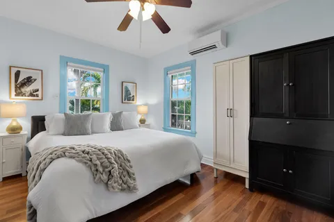 a bedroom with a large bed and a chandelier