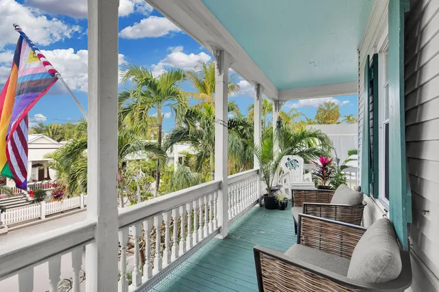 a living room filled with furniture and a potted plant