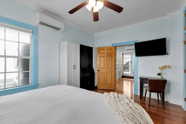 a bedroom with a bed and a television