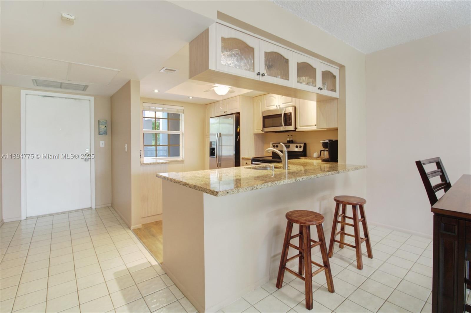 a kitchen with stainless steel appliances granite countertop a sink and cabinets