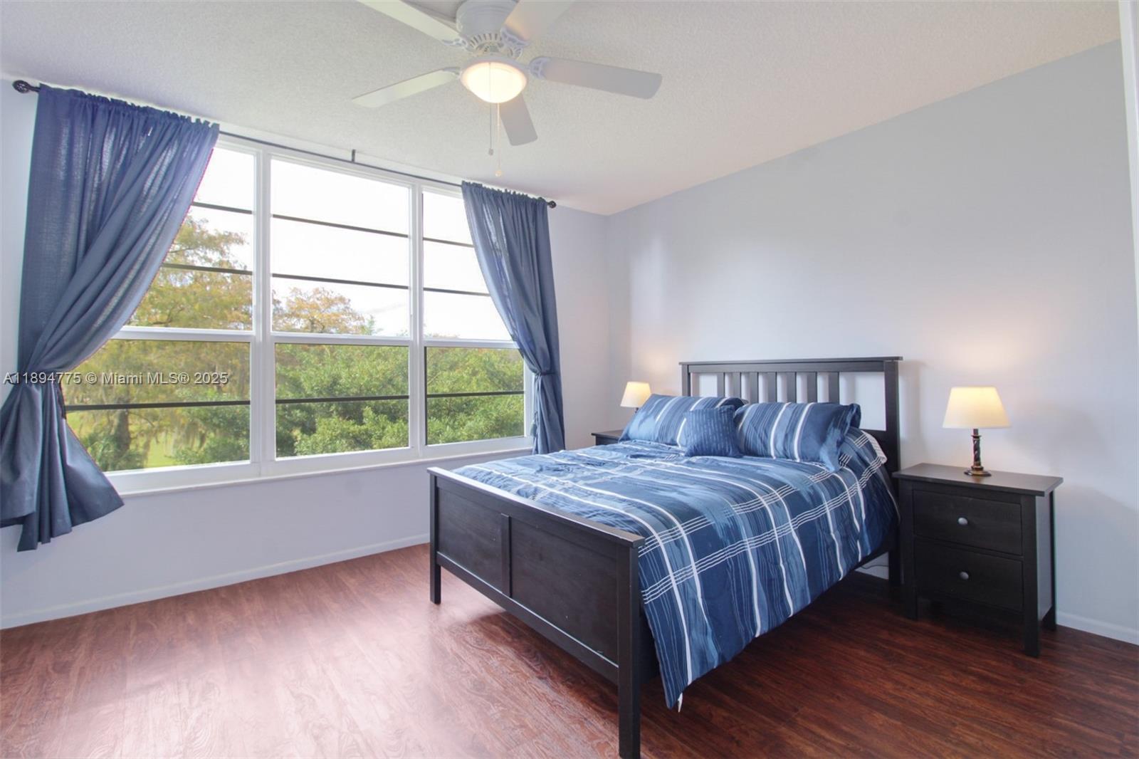 605 Oaks Drive, Unit 305 Pompano Beach, FL 33069 - Photo 15 of 31 a bedroom with a bed and a large window