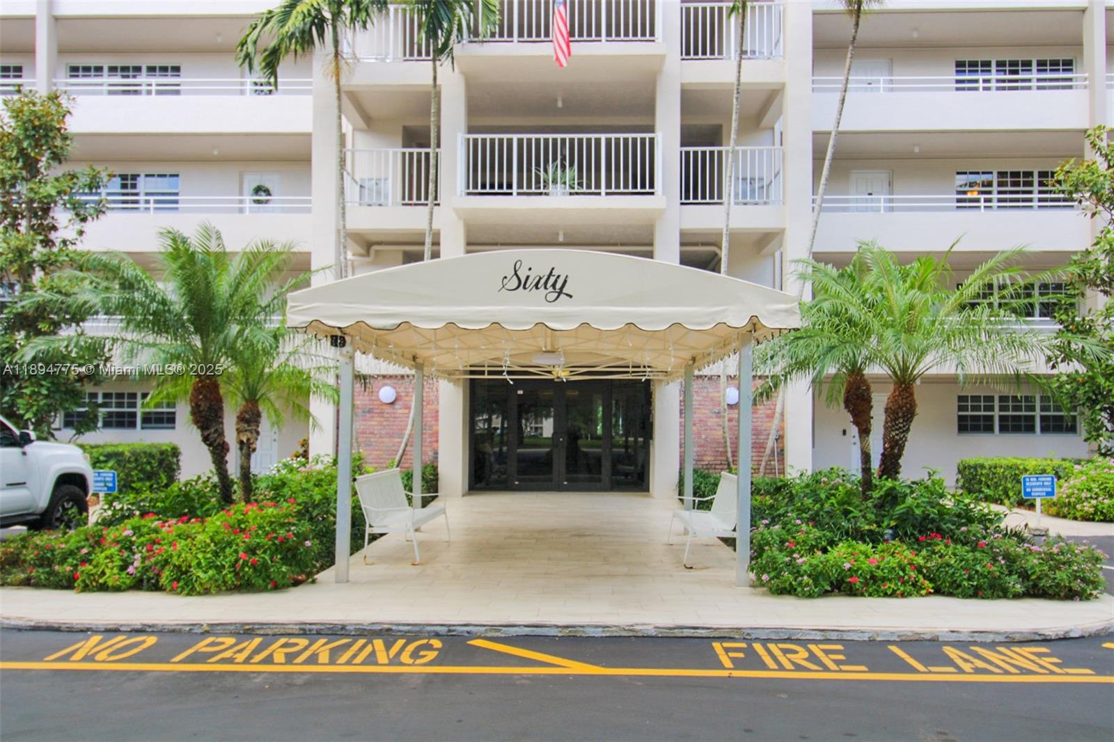 605 Oaks Drive, Unit 305 Pompano Beach, FL 33069 - Photo 23 of 31 a front view of a building with garden and parking