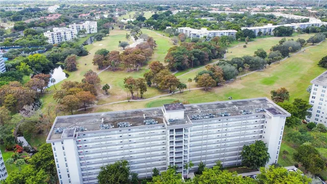 an aerial view of residential houses with outdoor space and lake view