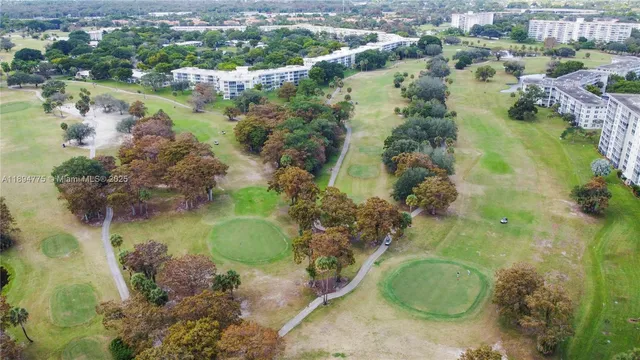 an aerial view of residential houses with outdoor space and lake view