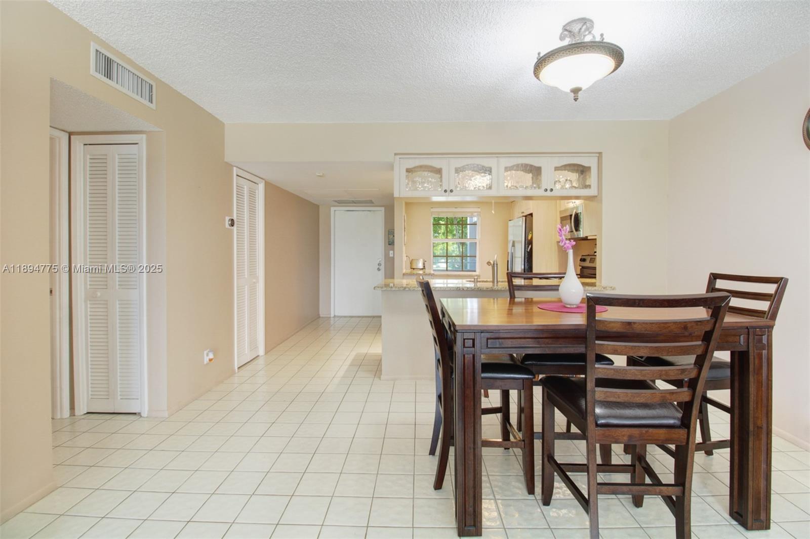 605 Oaks Drive, Unit 305 Pompano Beach, FL 33069 - Photo 7 of 31 a view of a dining room with furniture window and wooden floor