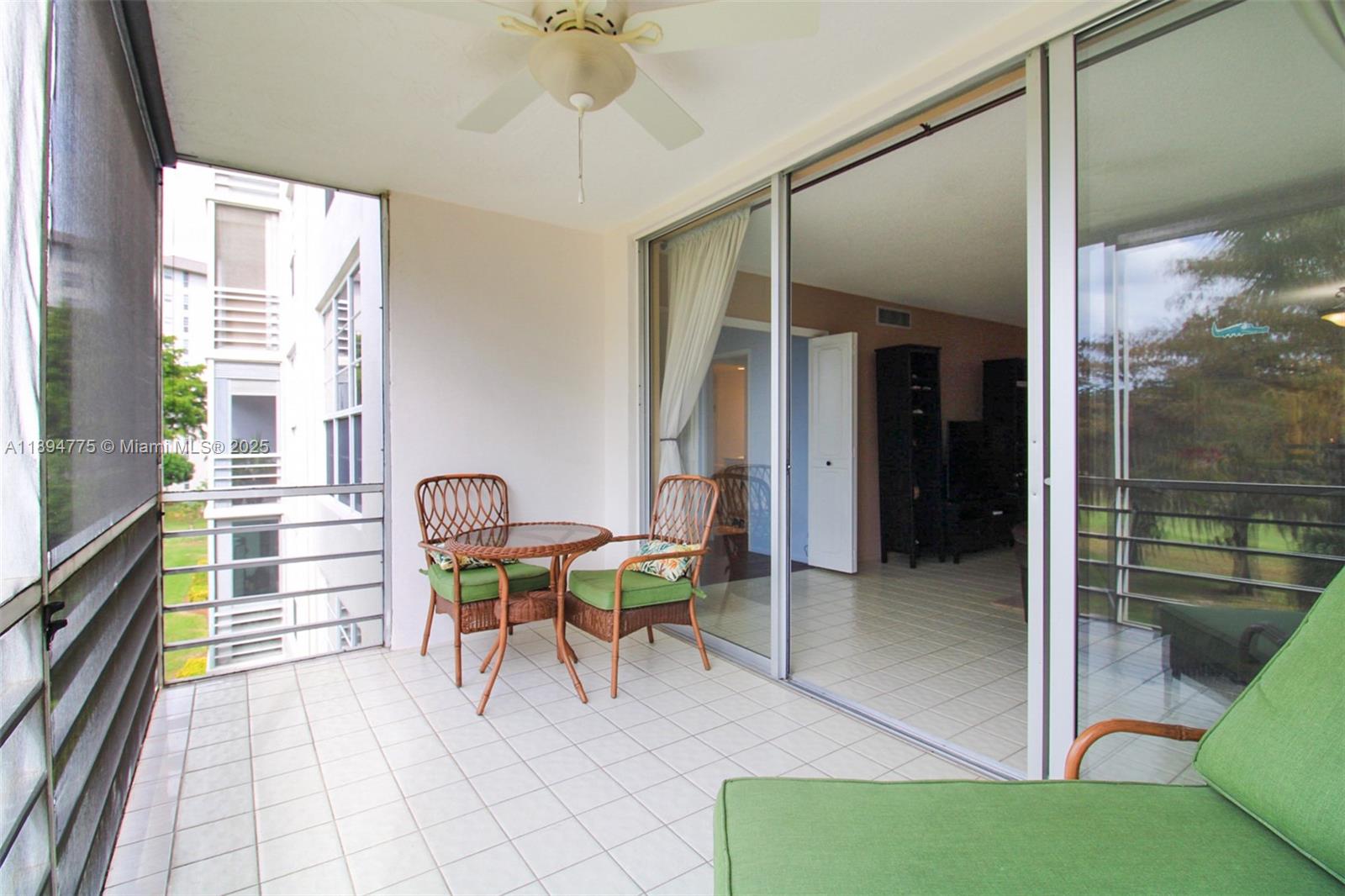605 Oaks Drive, Unit 305 Pompano Beach, FL 33069 - Photo 10 of 31 a view of a dining room with furniture a chandelier and a large window