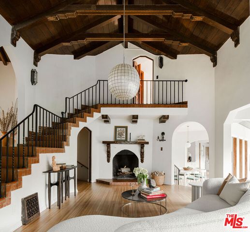 a living room with furniture a fireplace and a table