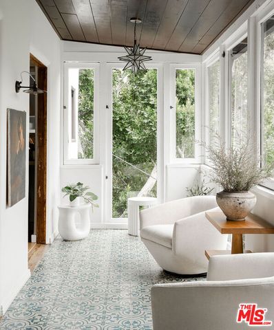 a view of a swimming pool with a bench and floor to ceiling window
